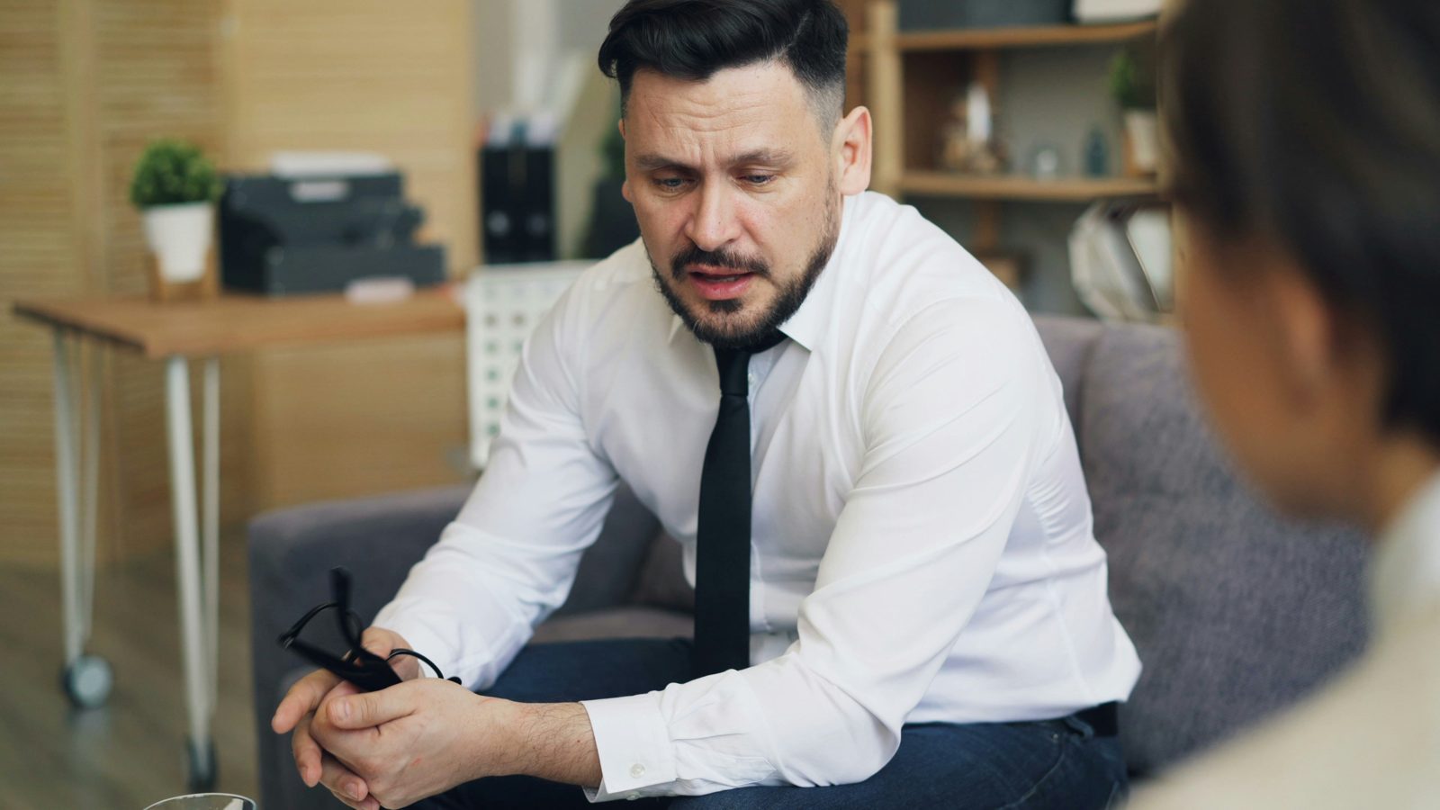 A DACA renewal lawyer leaning forward to talk a client through the renewal in his office