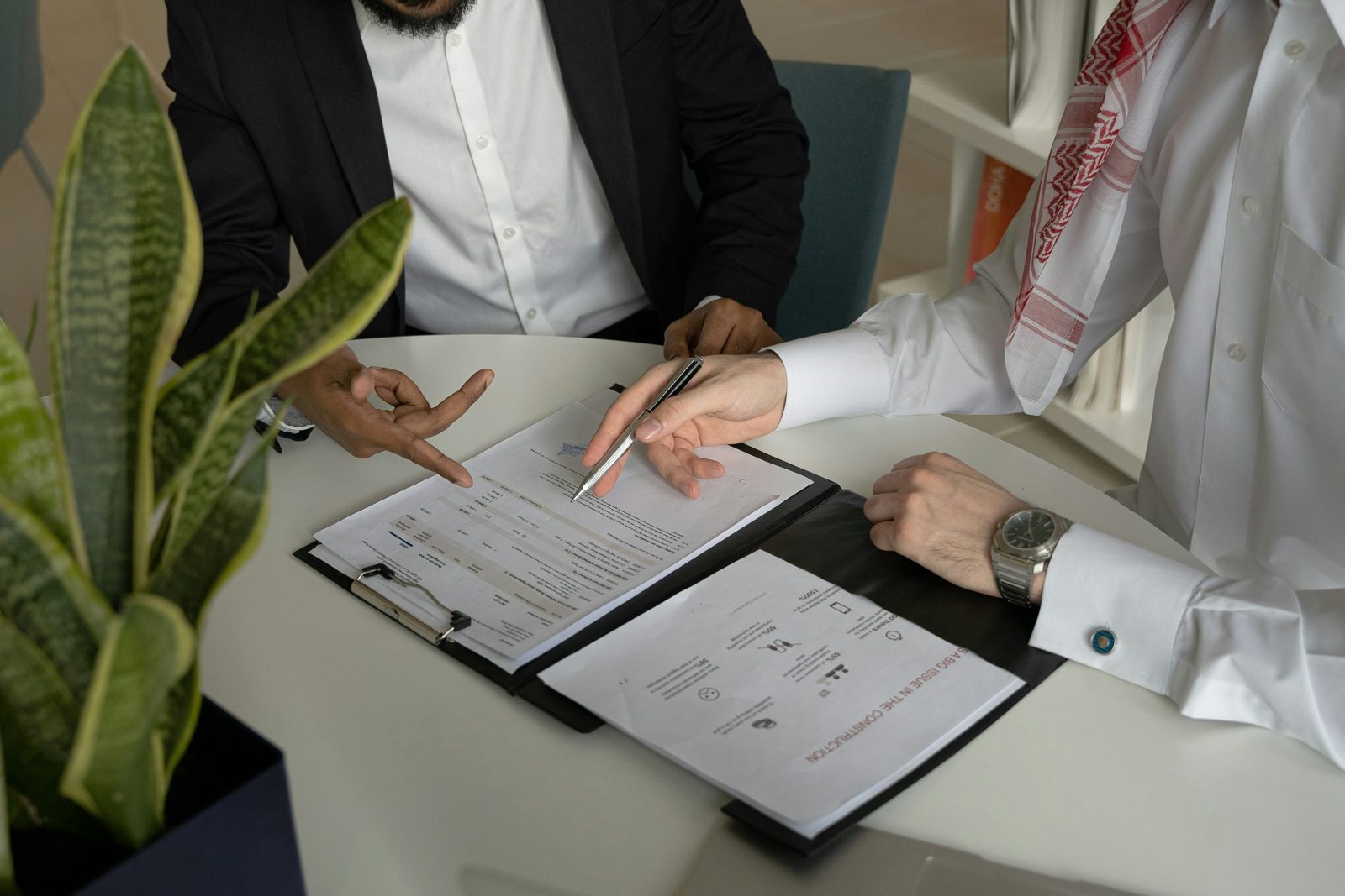 An attorney and client reading a filing folder together at an immigration document review