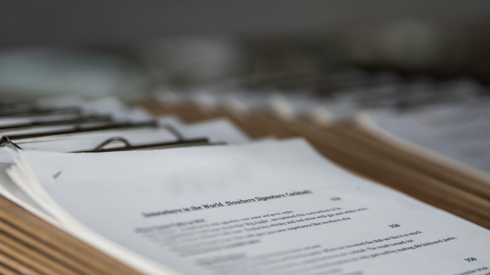 A clipped stack of printed employment immigration petitions on a desk