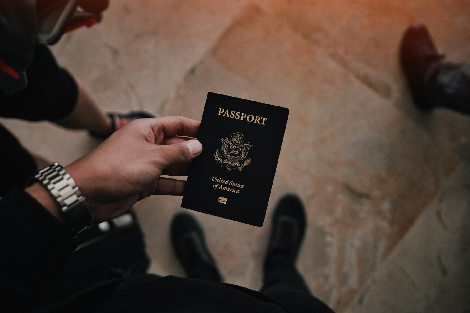 Hands holding a United States passport, the document a work visa is issued into