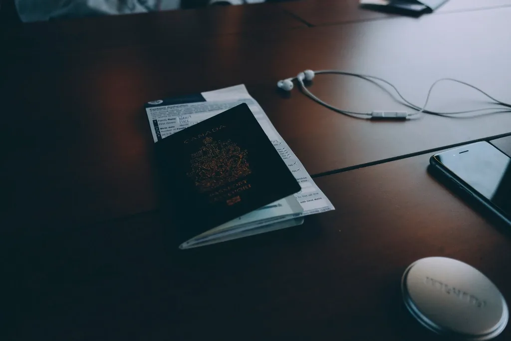 A passport resting on a completed form on a wooden desk, ready for a USCIS interview appointment