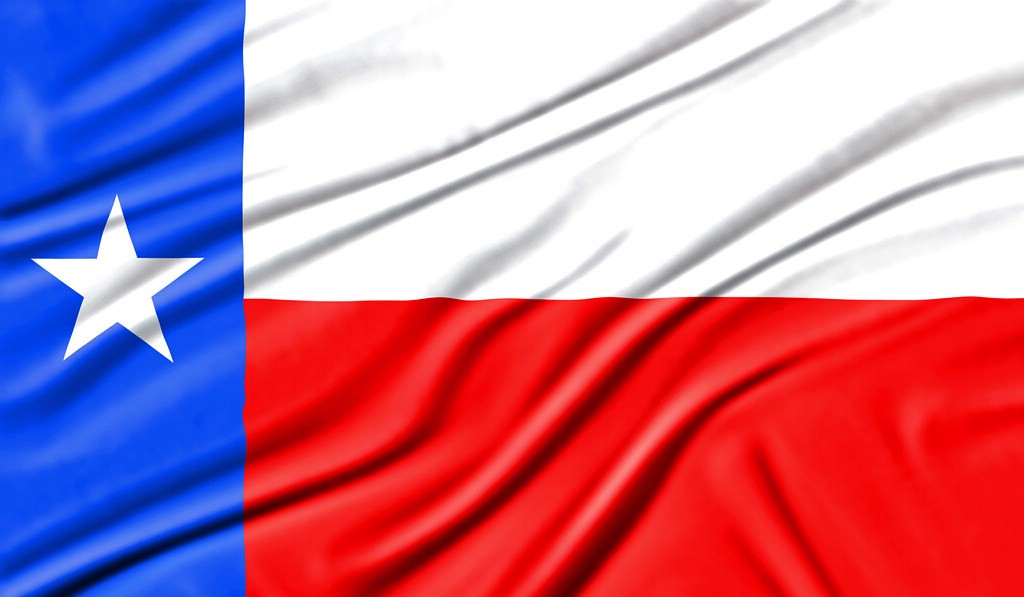 The Texas flag, blue field with its white star beside the white and red bars